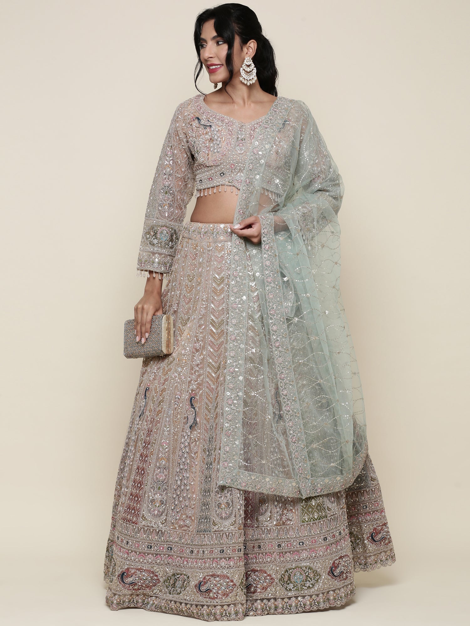 Beige net heavy embroidered three piece ghagra set