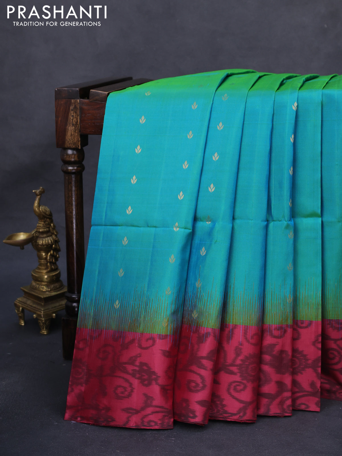 Ikat soft silk saree dual shade of teal bluish green and pink shade with allover zari woven buttas and ikat style border