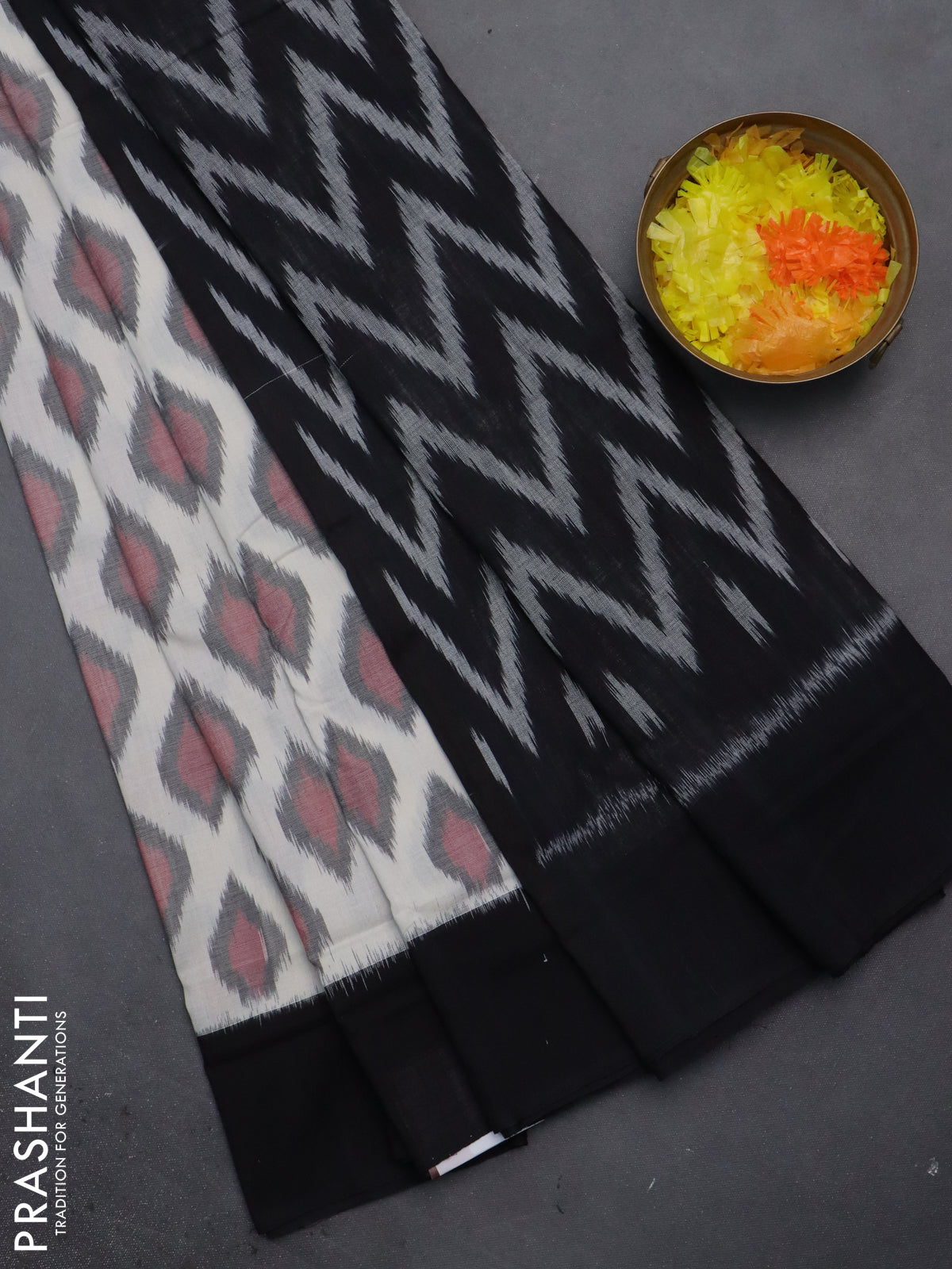 Ikat cotton saree off white and black with allover ikat butta weaves and simple border