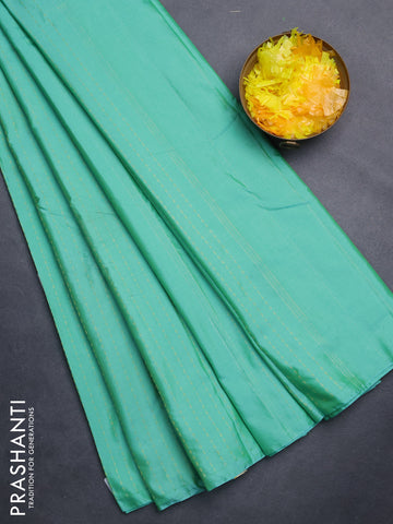 Arani semi silk saree teal green with allover zari weaves in borderless style