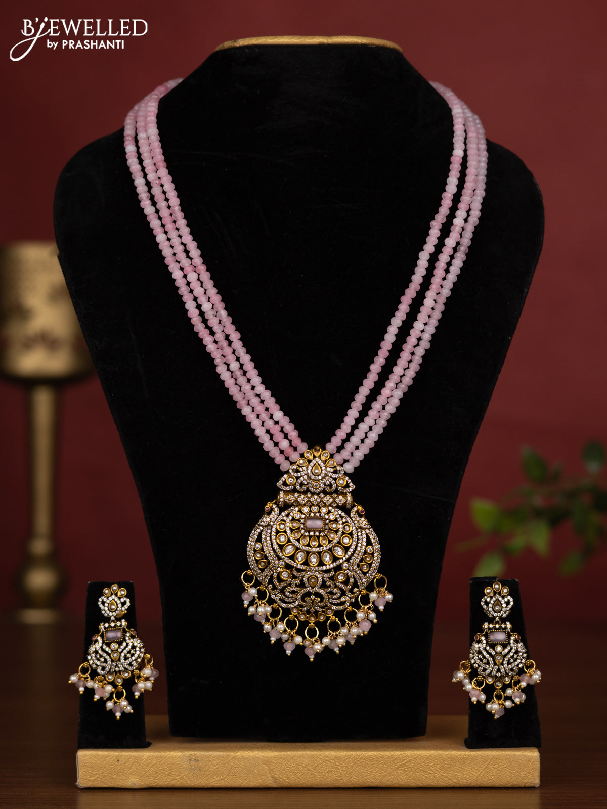 Beaded triple layer baby pink necklace with cz stones and pearl & beads hanging in victorian finish