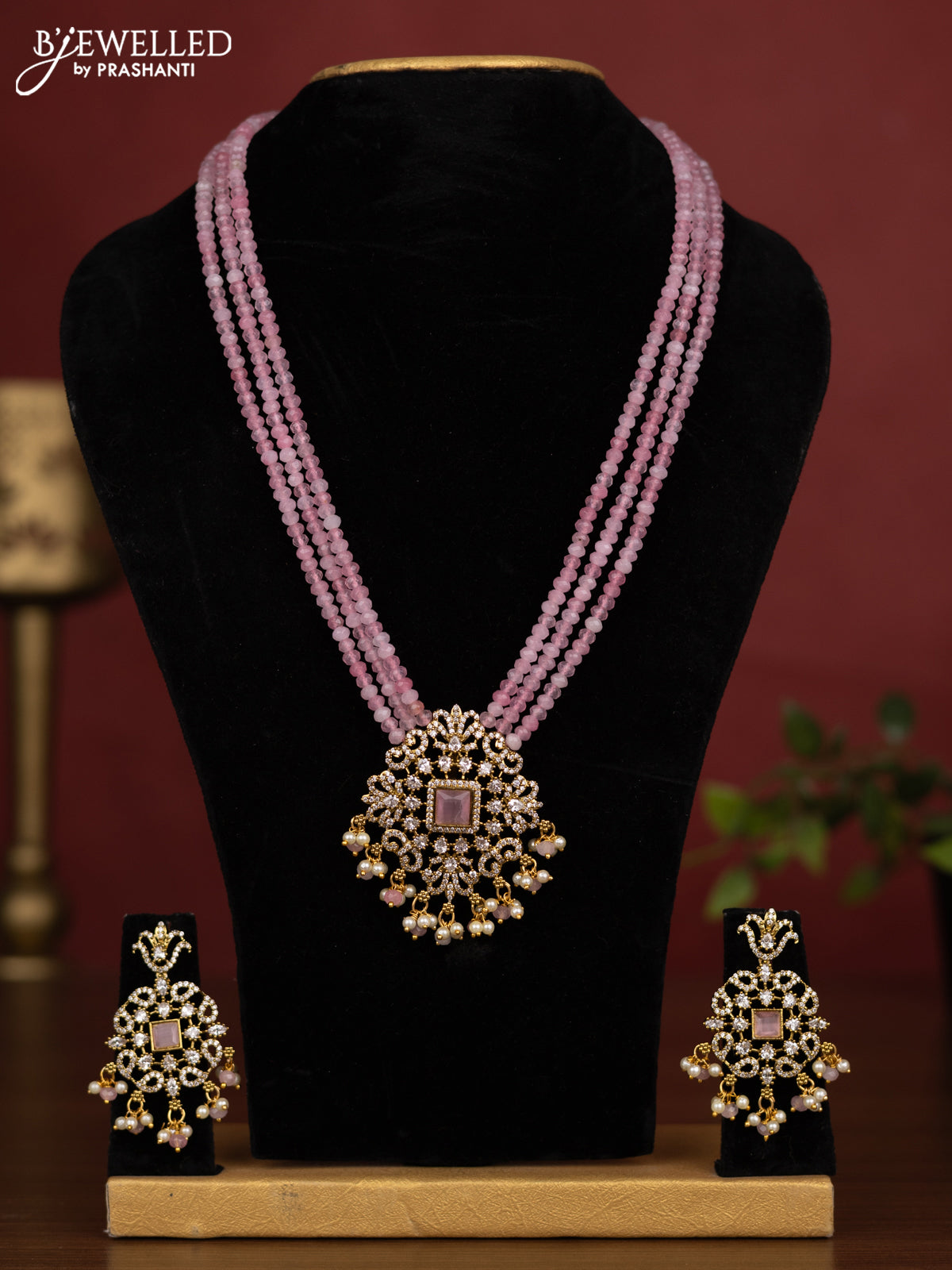 Beaded triple layer baby pink necklace with cz stones and pearl & beads hanging in victorian finish