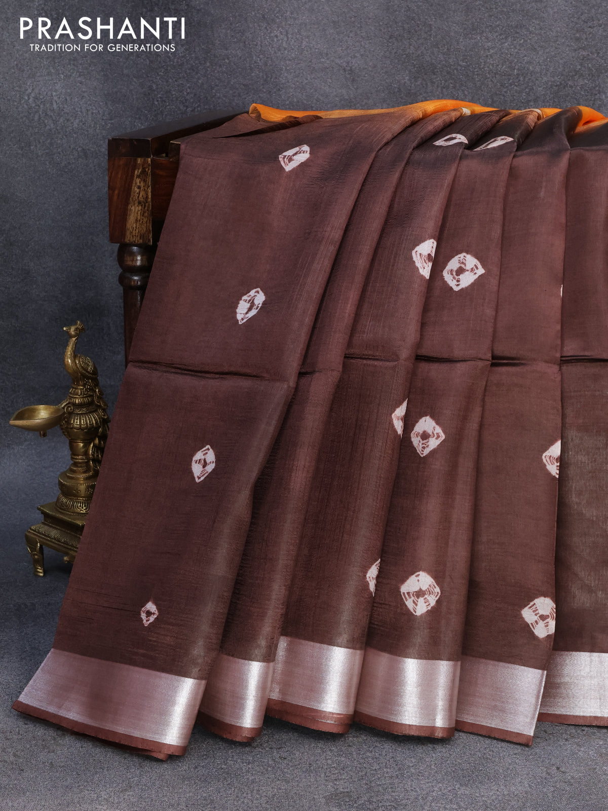 Banana silk saree orange and deep coffee brown with allover batik butta prints and silver zari woven border