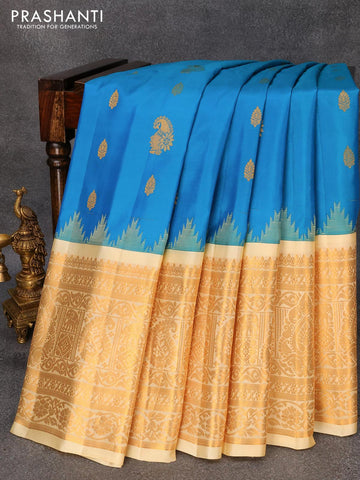 Pure gadwal silk saree dual shade of teal blue and cream with zari woven buttas and temple design long zari woven border